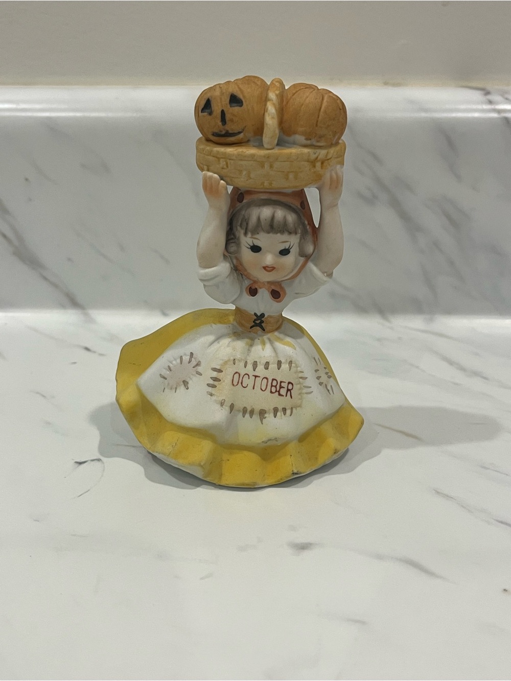 Vintage October Figurine Girl Holding Basket with Pumpkins